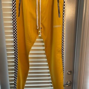 Yellow joggers with black and white checkers on the side, Karger on left.